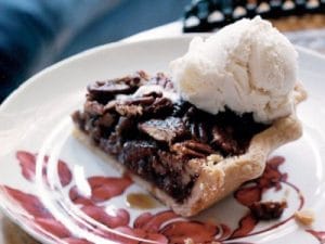 slice of texas pecan pie with scoop of ice cream of top