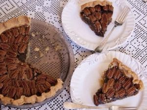 mexican chocolate pecan pie with two slices cut out on plates