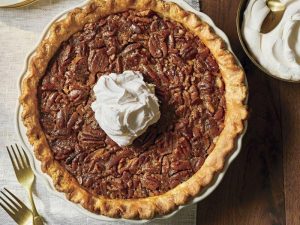 whole texas pecan pie with whipped cream