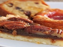 pecan pie slice in front of other pastries