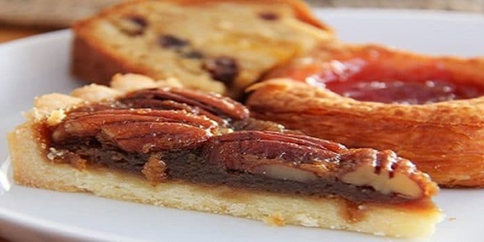 pecan pie slice in front of other pastries