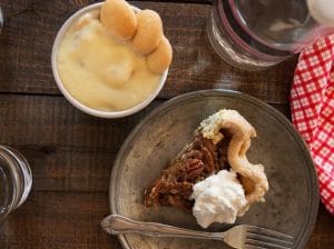 slice of pecan pie with banana pudding side