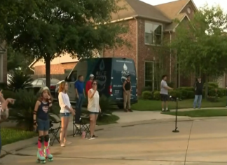 neighbors standing in driveway standing apart