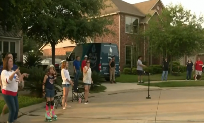 neighbors standing in driveway standing apart