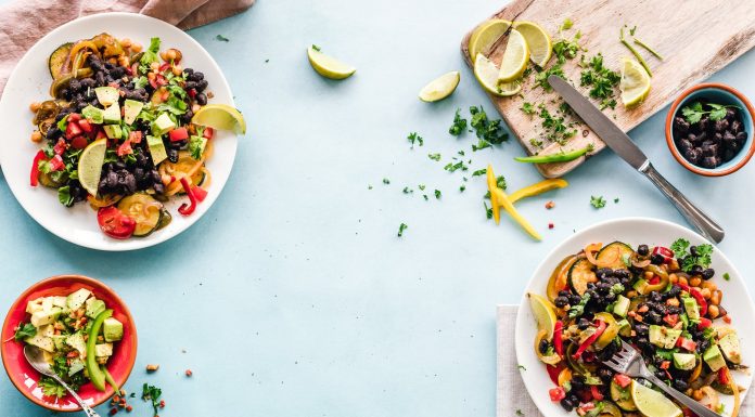 image contains fruit salad in bowls on table
