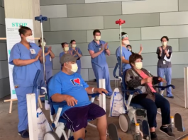 elderly couple leaving hospital in wheelchairs