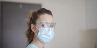 woman in blue shirt wearing face mask