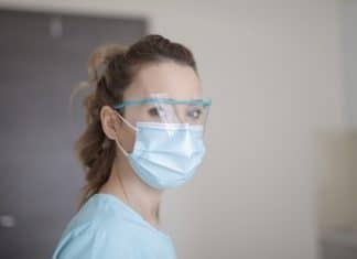 woman in blue shirt wearing face mask