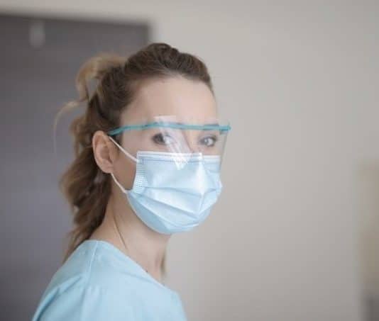 woman in blue shirt wearing face mask
