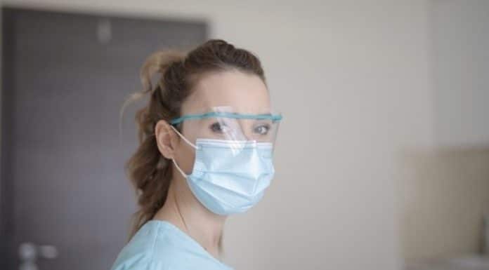 woman in blue shirt wearing face mask