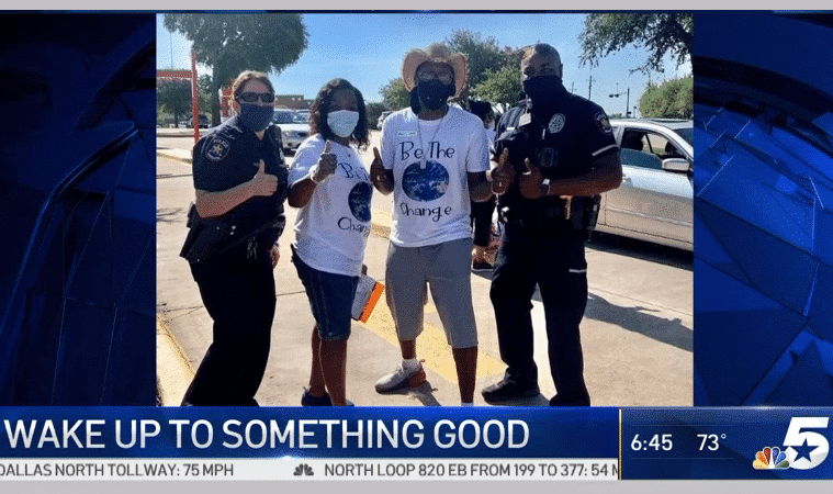 volunteers with carrollton tx police officers at a $10,000 gasoline give away in 2020