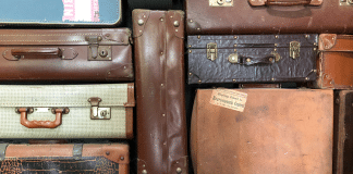 stack of used suitcases
