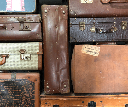 stack of used suitcases