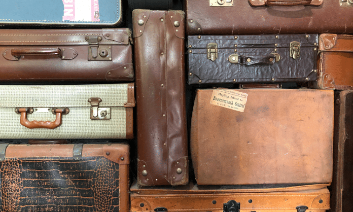 stack of used suitcases