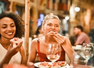 women sitting outside eating on a patio