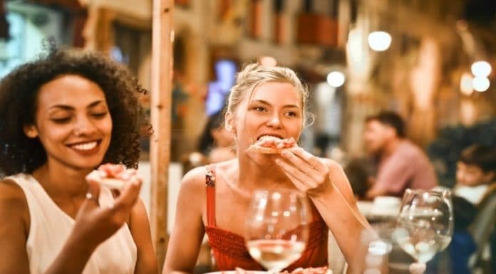 women sitting outside eating on a patio