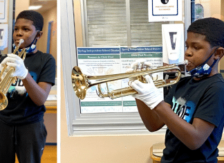 young Texas boy / student plays his band new trumpet at school in Houston