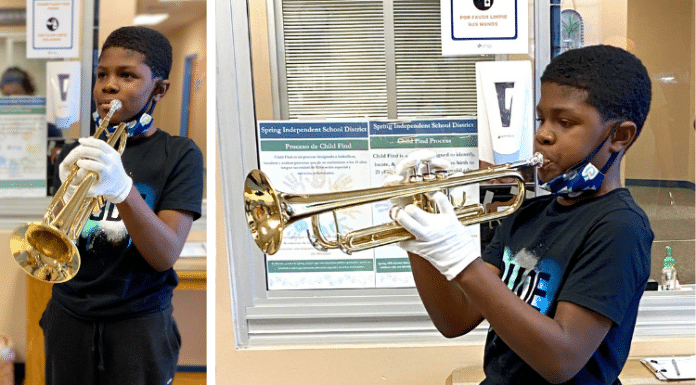 young Texas boy / student plays his band new trumpet at school in Houston