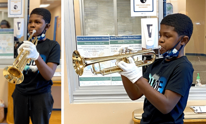 young Texas boy / student plays his band new trumpet at school in Houston