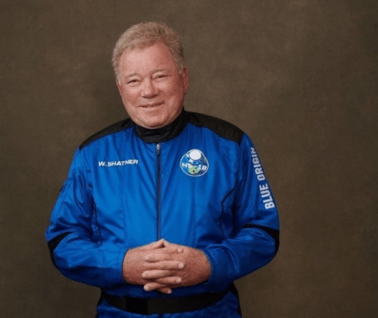 William Shatner dressed in a blue astronaut suit