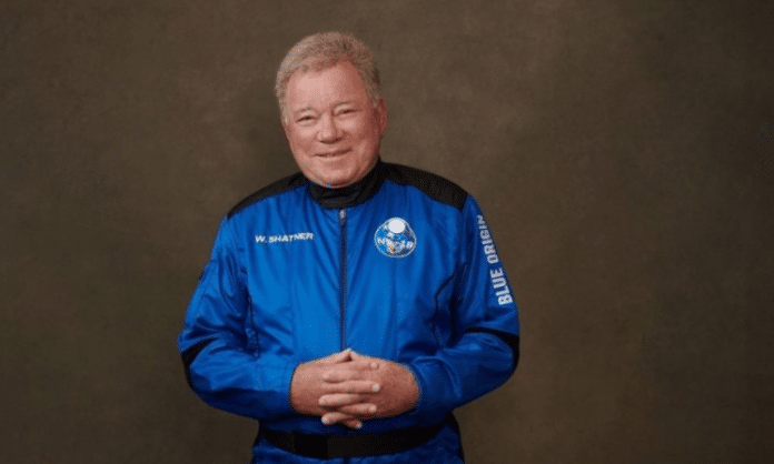 William Shatner dressed in a blue astronaut suit