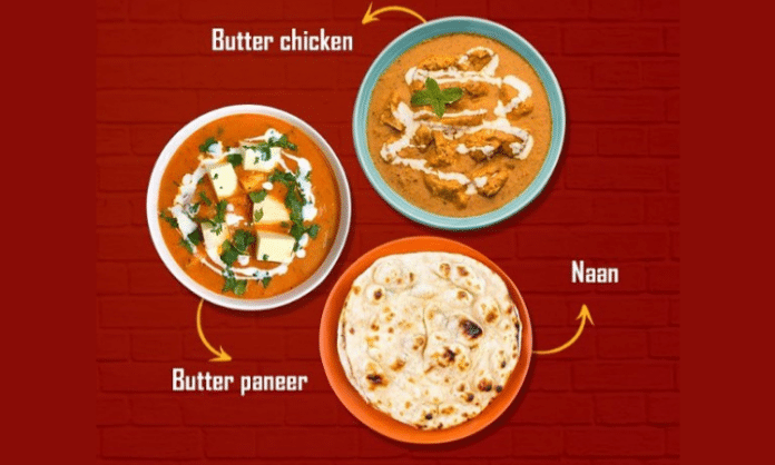 indian food on plates including butter chicken, butter paneer, and naan bread