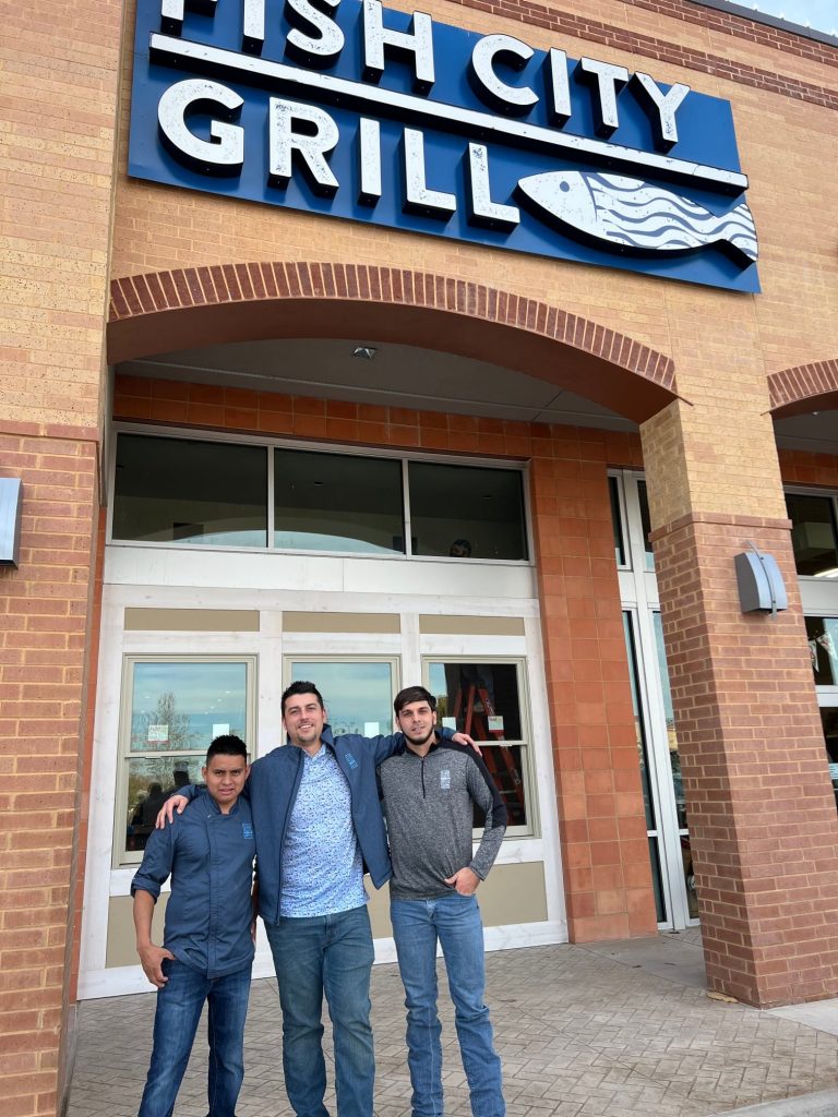 group on=f men outside newly rebuilt Fish City Grill