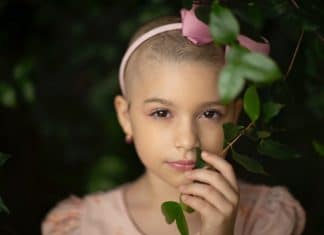 Houston Teen Entrepreneur Has Donated Over 10,000 Lip Balms To Kids With Cancer Gentle girl with short hair touching plant