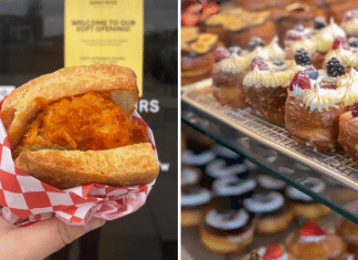 hand holding Nashville hot chicken sandwich in front of Honeybird and trays of gourmet donuts