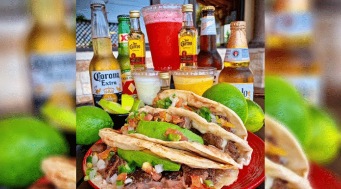 plate of tacos on a table surrounded by beer