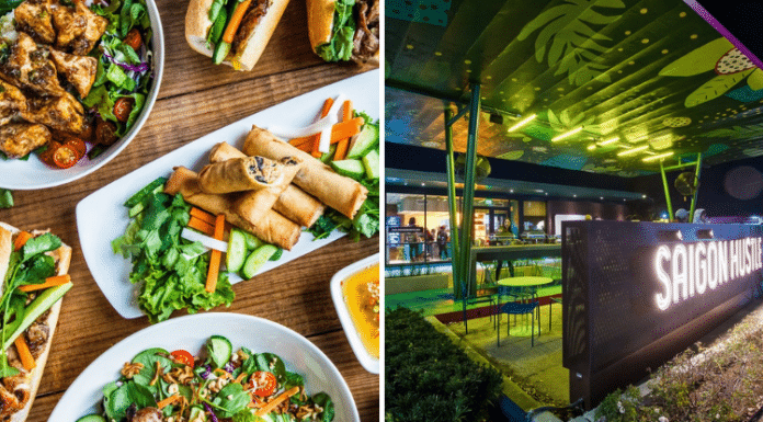 Vietnamese food on a table and Saigon Hustle neon sign on Houston patio